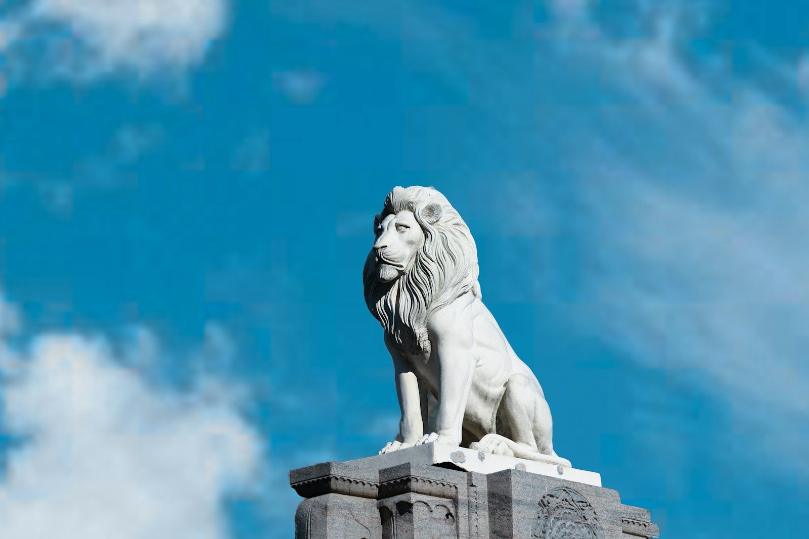 Photo by Gaurav Sharma Ancient stories: white lion statue under blue sky during daytime
