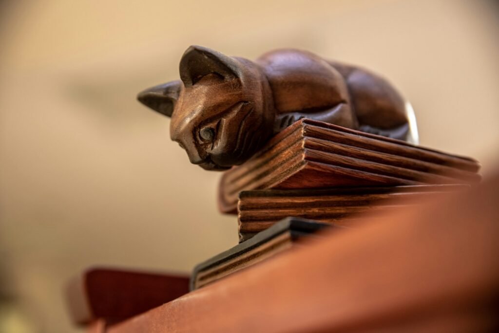 Ancient Cat brown wooden animal figurine on brown wooden table