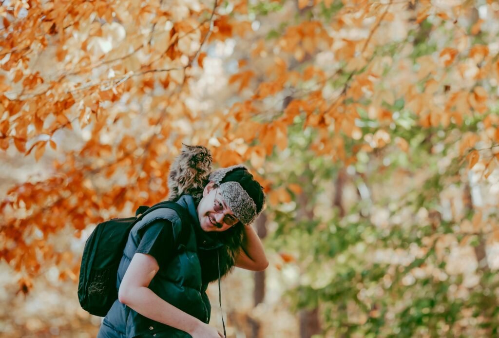 a man with a backpack and a cat on his back
