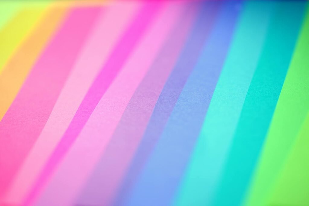 Colorful abstract background with vibrant pastel stripes creating a gradient pattern.
