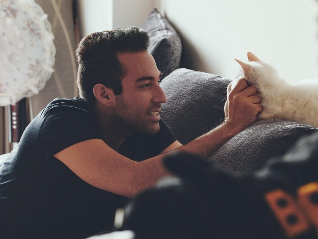 man fetching cats face