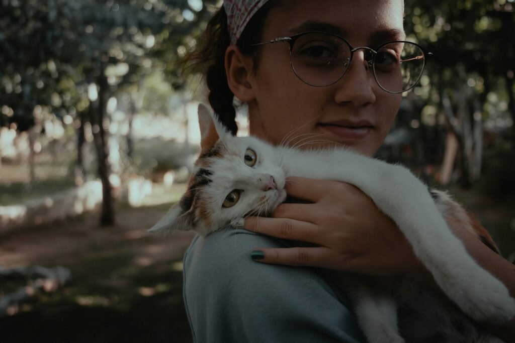 cat bond:. woman in blue sweater holding white cat