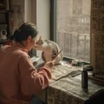 Woman practicing calligraphy with her cat in a warm New York apartment.
