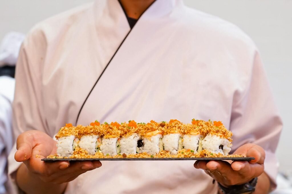 Chef Holding Sushi Roll