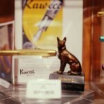 A display of pens and a statue of a dog