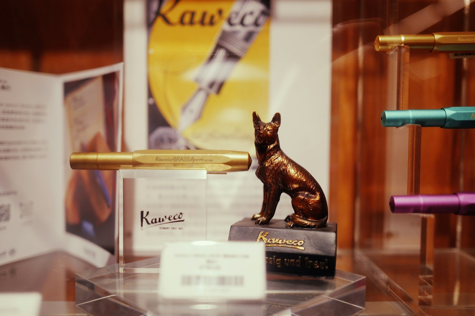 A display of pens and a statue of a dog