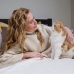 Woman in Sweater Holding Orange and White Cat