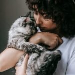 Curly woman with charming cat